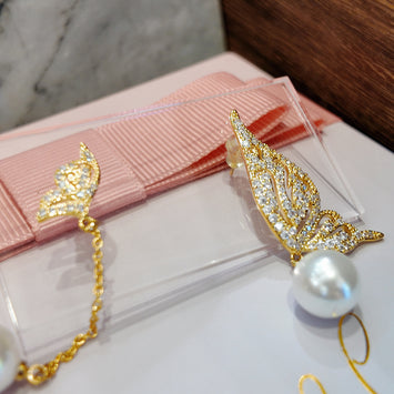 Wings with hanging pearl earrings