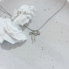 Sliver bow and pink heart necklace
