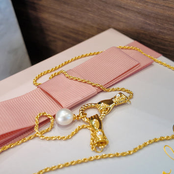 Gloves with hanging pearl necklace