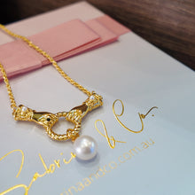 Gloves with hanging pearl necklace