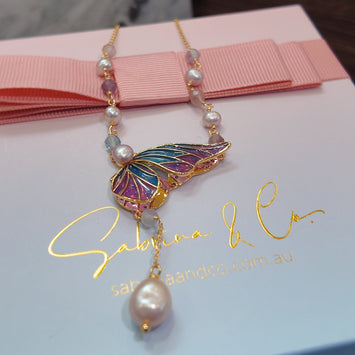 Butterfly with hanging pearl necklace