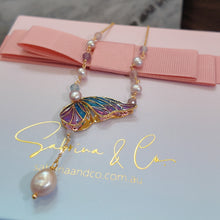 Butterfly with hanging pearl necklace