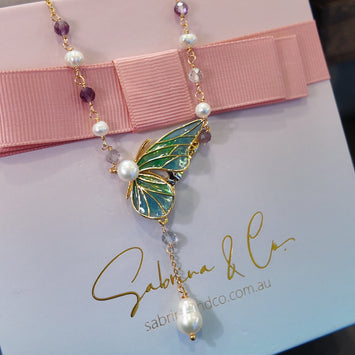 Butterfly with hanging pearl necklace