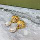 Shell with hanging pearl earrings