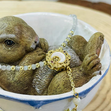 Shell moon with hanging pearl necklace