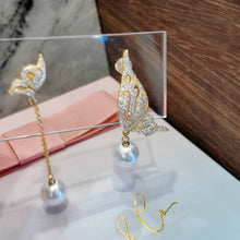 Wings with hanging pearl earrings