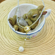 Shell moon with hanging pearl necklace