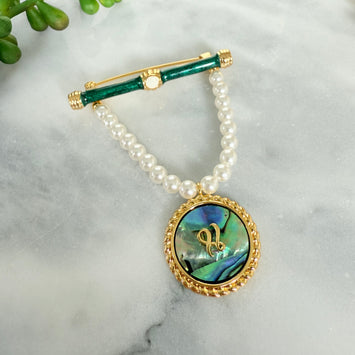 Hanging pearl and shell brooch
