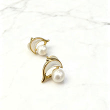Shell dolphin with pearl earrings