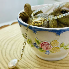 Shell moon with hanging pearl necklace