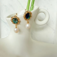 Shell with hanging pearl earrings