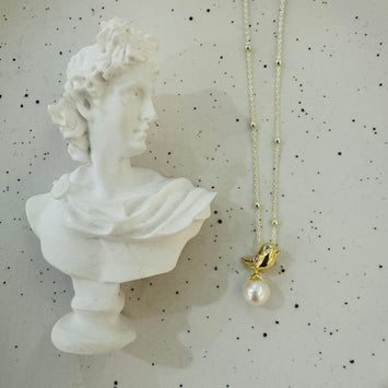 Bird and pearl necklace