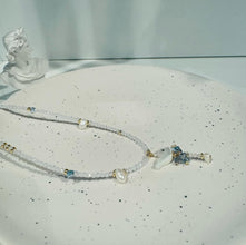 Hanging shell bird with pearl necklace