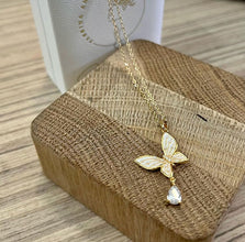 Pearl butterfly with hanging diamond necklace