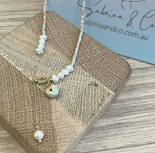 Gemstones with hanging pearl necklace