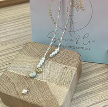 Gemstones with hanging pearl necklace