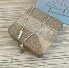 Gemstones with hanging pearl necklace